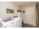 Bright laundry room with modern washer and dryer, ample storage space, and stylish decor at 6400 Woodland Ln, McCordsville, IN 46055