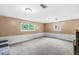 Spacious carpeted basement with neutral walls and two large windows for natural light at 6616 W 15Th St, Indianapolis, IN 46214