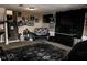 Finished basement with a comfortable seating area, carpet flooring, and sports memorabilia, perfect for entertainment at 6616 W 15Th St, Indianapolis, IN 46214