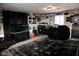 Spacious finished basement with a black bean bag, carpet, and sports memorabilia, offering a relaxed entertainment area at 6616 W 15Th St, Indianapolis, IN 46214
