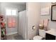 Cozy bathroom featuring a shower with curtain, a comfort height toilet, and soft pink accents for a relaxing feel at 6616 W 15Th St, Indianapolis, IN 46214