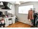 Bright bedroom featuring wood floors, a vanity, ceiling fan, and a large window that fills the space with natural light at 6616 W 15Th St, Indianapolis, IN 46214