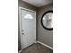 Bright entryway with a white door and round mirror, offering a glimpse into the home's welcoming interior at 6616 W 15Th St, Indianapolis, IN 46214