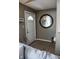 Inviting entryway features tile flooring, a white front door, and a stylish round mirror creating a welcoming ambiance at 6616 W 15Th St, Indianapolis, IN 46214
