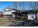 Charming split-level home featuring a brick and vinyl exterior with attached garage and extended driveway at 6616 W 15Th St, Indianapolis, IN 46214