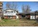 Charming split-level home featuring a brick and vinyl exterior with attached garage at 6616 W 15Th St, Indianapolis, IN 46214