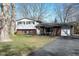 Charming split-level home featuring a brick and vinyl exterior with attached garage and driveway at 6616 W 15Th St, Indianapolis, IN 46214