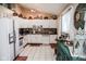 Fully-equipped kitchen showcasing white appliances, ample cabinet storage, and contemporary backsplash at 6616 W 15Th St, Indianapolis, IN 46214