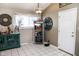 Cozy kitchen eating area featuring natural light, decorative hutch, and white tiled floors at 6616 W 15Th St, Indianapolis, IN 46214