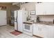 Bright kitchen featuring white appliances, plentiful cabinet space and stylish countertop decor at 6616 W 15Th St, Indianapolis, IN 46214