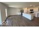 Spacious open-concept kitchen and living area with stainless steel appliances and a large center island at 6635 Sulgrove Pl, Indianapolis, IN 46221
