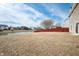 Large backyard with pond access, lawn and fence under blue skies and scattered clouds at 6677 W Longview Dr, McCordsville, IN 46055