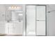 Bathroom featuring a double vanity with elegant fixtures and a walk-in shower with glass doors at 6677 W Longview Dr, McCordsville, IN 46055