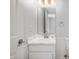 Bathroom with single sink vanity, large mirror, neutral wall colors and paneled walls at 6677 W Longview Dr, McCordsville, IN 46055