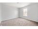 Bright bedroom features neutral paint, carpet, and a window to let in natural light at 6677 W Longview Dr, McCordsville, IN 46055