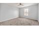 Cozy carpeted bedroom with neutral walls, ceiling fan, and a window overlooking the neighborhood at 6677 W Longview Dr, McCordsville, IN 46055