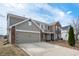 A well-maintained house showcasing a blend of vinyl siding and brick, complemented by an attached two-car garage and spacious driveway at 6677 W Longview Dr, McCordsville, IN 46055