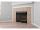 Tiled fireplace with white mantel and black grate, adding warmth and charm to the living space at 6677 W Longview Dr, McCordsville, IN 46055