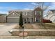 Inviting two-story home featuring a blend of vinyl siding, brick accents, attached garage, and well-maintained front yard at 6677 W Longview Dr, McCordsville, IN 46055