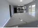 Open-concept kitchen with gray walls and a white countertop island at 6677 W Longview Dr, McCordsville, IN 46055