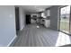 Open kitchen leading to a sunlit patio, gray walls, and stainless steel appliances at 6677 W Longview Dr, McCordsville, IN 46055