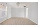 Spacious living room with light wood floors, complemented by a modern chandelier, and neutral paint at 6677 W Longview Dr, McCordsville, IN 46055