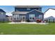 Landscaped backyard patio with outdoor seating and barbecue grill at 6919 Sable Point Dr, Brownsburg, IN 46112