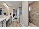Modern bathroom featuring double sinks, and a walk-in shower next to the main bedroom at 6919 Sable Point Dr, Brownsburg, IN 46112