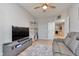 Comfortable room features a gray leather reclining sofa, ceiling fan, and a large television at 6919 Sable Point Dr, Brownsburg, IN 46112