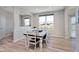 Dining room showcases a wood table set with white chairs and a large picture window at 6919 Sable Point Dr, Brownsburg, IN 46112