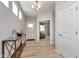 Bright entryway with light wood floors, console table with decor, and white front door at 6919 Sable Point Dr, Brownsburg, IN 46112