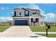 Two-story home boasts a front-facing two-car garage and a cozy front porch with rocking chairs at 6919 Sable Point Dr, Brownsburg, IN 46112