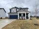 Traditional home featuring a two-car garage and a covered front porch at 6919 Sable Point Dr, Brownsburg, IN 46112