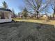 Expansive backyard featuring mature trees, a shed, and a spacious grassy lawn at 70 Joseph Ln, Whiteland, IN 46184