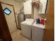 Functional laundry room boasts a washer, dryer, water heater, and upper cabinets for storage at 70 Joseph Ln, Whiteland, IN 46184