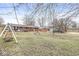 This backyard features a swing, shed, and patio area, perfect for outdoor entertaining at 714 School St, Greenfield, IN 46140