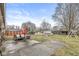 This backyard offers a patio, sitting area, sheds, and swing set with a big green space at 714 School St, Greenfield, IN 46140