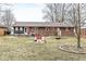 This backyard is spacious, featuring a patio area, play house, and beautiful landscaping at 714 School St, Greenfield, IN 46140