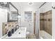 This bathroom features tiled walls, a shower with bathtub, and a sink with a mirror at 714 School St, Greenfield, IN 46140