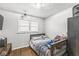 This bedroom boasts hardwood floors, a window, neutral paint, and a modern light fixture at 714 School St, Greenfield, IN 46140