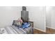 This bedroom has hardwood floors, a nice window, and a dark toned armoire at 714 School St, Greenfield, IN 46140