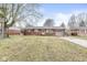 Charming brick home with an attached garage and well-maintained front yard at 714 School St, Greenfield, IN 46140