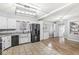Bright eat-in kitchen boasts stainless steel appliances, white cabinets, and updated countertops at 714 School St, Greenfield, IN 46140