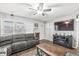 Living room features hardwood floors, a ceiling fan, a built-in fireplace, and modern television at 714 School St, Greenfield, IN 46140