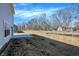 Side view of the backyard with a concrete patio at 7168 Jackson Dr, Cumberland, IN 46229