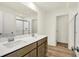 Bathroom featuring double sinks, modern fixtures, and vinyl flooring at 7168 Jackson Dr, Cumberland, IN 46229