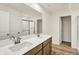 Bathroom showcasing double vanity, shower, and vinyl flooring at 7168 Jackson Dr, Cumberland, IN 46229