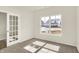 Bright bedroom with plush carpet, a large window, and stylish French doors at 7168 Jackson Dr, Cumberland, IN 46229
