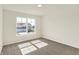 A clean, empty bedroom showing the window, carpet, and electrical outlets at 7168 Jackson Dr, Cumberland, IN 46229