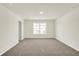 A sunlit bedroom boasts a neutral color palette and soft carpeting at 7168 Jackson Dr, Cumberland, IN 46229
